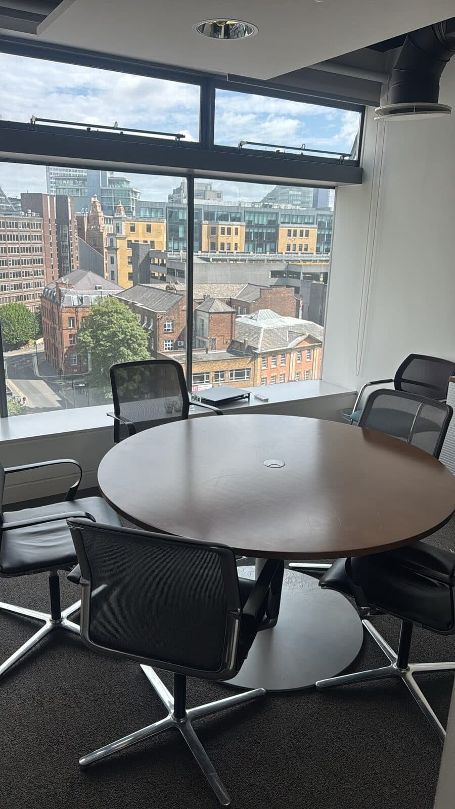 Office boardroom with meeting table and chairs during a commercial office relocation